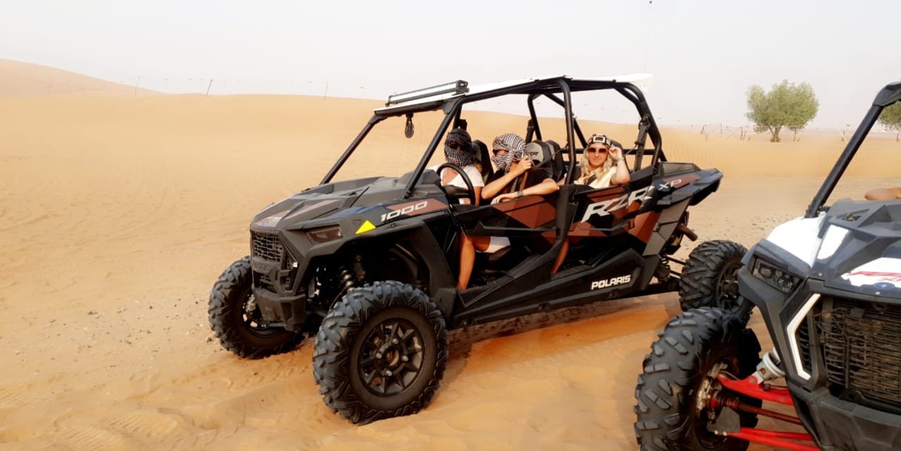 A red four-seater dune buggy ready for an adventure